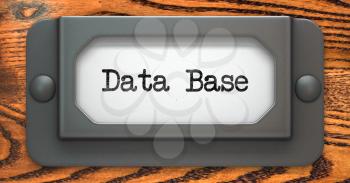 Data Base - Inscription on File Drawer Label on a Wooden Background.