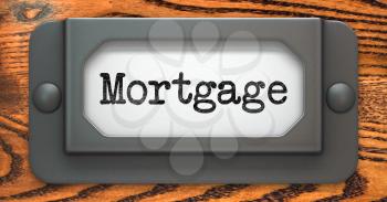 Mortgage - Inscription on File Drawer Label on a Wooden Background.