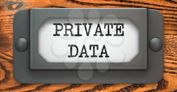 Private Data - Inscription on File Drawer Label on a Wooden Background.