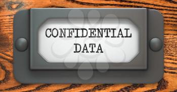 Confidential Data - Inscription on File Drawer Label on a Wooden Background.