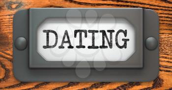 Dating - Inscription on File Drawer Label on a Wooden Background.