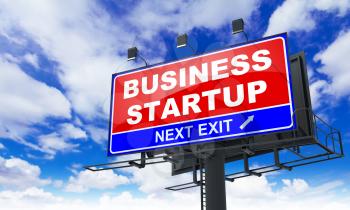 Business Startup Inscription on Red Billboard on Sky Background.