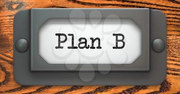 Plan B Inscription on File Drawer Label on a Wooden Background.