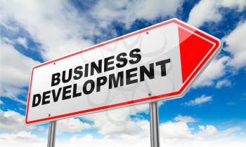 Business Development - Inscription on Red Road Sign on Sky Background.