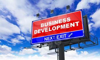 Business Development - Red Billboard on Sky Background. Business Concept.