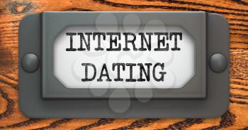 Internet Dating - Inscription on File Drawer Label on a Wooden Background.