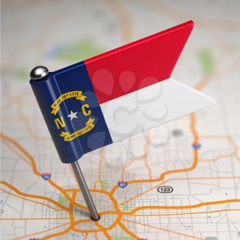 Small Flag of North Carolina on a Map Background with Selective Focus.