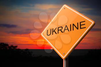 Ukraine on Warning Road Sign on Sunset Sky Background.