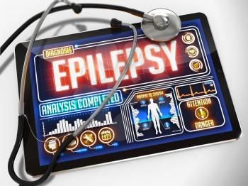 Epilepsy on the Display of Medical Tablet and a Black Stethoscope on White Background.