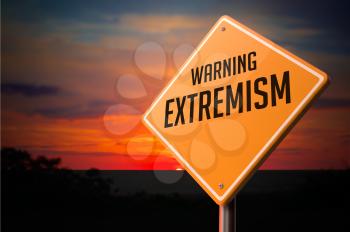Extremism on Warning Road Sign on Sunset Sky Background.