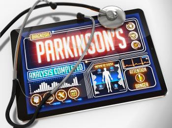 Medical Tablet with the Diagnosis of Parkinson's on the Display and a Black Stethoscope on White Background.