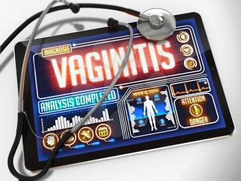 Medical Tablet with the Diagnosis of Vaginitis on the Display and a Black Stethoscope on White Background.
