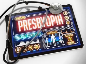 Medical Tablet with the Diagnosis of Presbyopia on the Display and a Black Stethoscope on White Background.