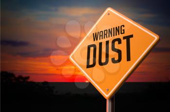 Dust on Warning Road Sign on Sunset Sky Background.