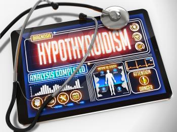 Hypothyroidism - Diagnosis on the Display of Medical Tablet and a Black Stethoscope on White Background.