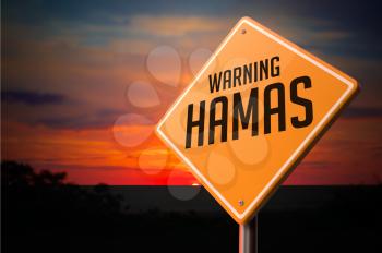 Hamas on Warning Road Sign on Sunset Sky Background.