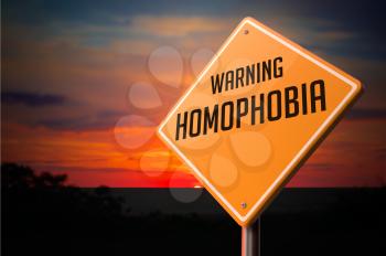 Homophobia on Warning Road Sign on Sunset Sky Background.