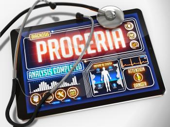 Progeria - Diagnosis on the Display of Medical Tablet and a Black Stethoscope on White Background.
