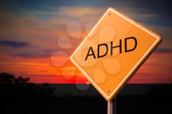 ADHD on Warning Road Sign on Sunset Sky Background.