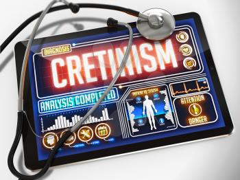 Cretinism - Diagnosis on the Display of Medical Tablet and a Black Stethoscope on White Background.