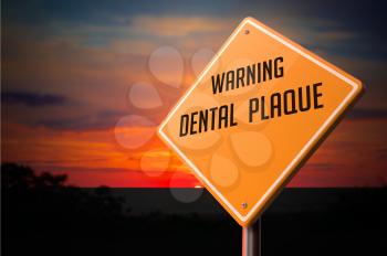 Dental Plaque on Warning Road Sign on Sunset Sky Background.