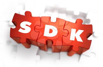 SDK - Software Development Kit - Text on Red Puzzles with White Background. 3D Render. 