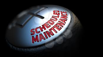 Scheduled Maintenance - Red Text on Black Gear Shifter with Leather Cover. Close Up View. Selective Focus.