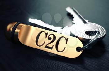 C2C - Customer to Customer - Concept. Keys with Golden Keyring on Black Wooden Table. Closeup View, Selective Focus, 3D Render. Toned Image.