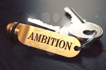 Keys with Word Ambition on Golden Label over Black Wooden Background. Closeup View, Selective Focus, 3D Render. Toned Image.