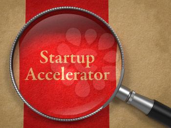 Startup Accelerator through Magnifying Glass on Old Paper with Red Vertical Line.