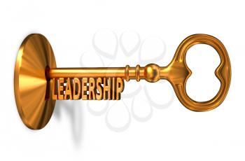 Leadership - Golden Key is Inserted into the Keyhole Isolated on White Background