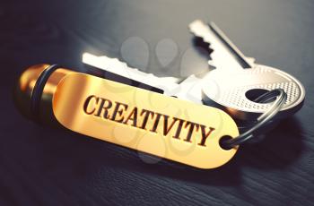 Keys with Word 'Creativity' on Golden Label over Black Wooden Background. Closeup View, Selective Focus, 3D Render. Toned Image.