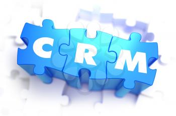 CRM - Customer Relationship Management - White Word on Blue Puzzles on White Background. 3D Render. 