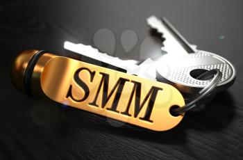SMM - Social Media Marketing - Concept. Keys with Golden Keyring on Black Wooden Table. Closeup View, Selective Focus, 3D Render.