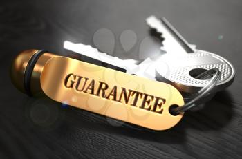 Guarantee - Bunch of Keys with Text on Golden Keychain. Black Wooden Background. Closeup View with Selective Focus. 3D Illustration.