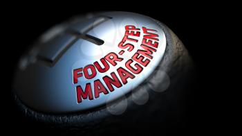 Four-Step Management - Red Text on Car's Shift Knob on Black Background. Close Up View. Selective Focus.