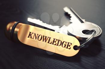 Keys to Knowledge - Concept on Golden Keychain over Black Wooden Background. Closeup View, Selective Focus, 3D Render. Toned Image.