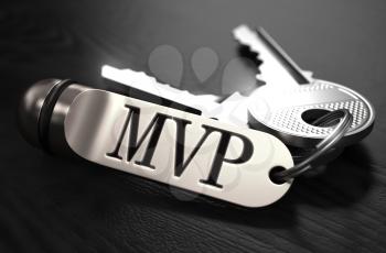MVP - Most Valuable Player - Concept. Keys with Keyring on Black Wooden Table. Closeup View, Selective Focus, 3D Render. Black and White Image.