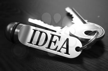 Idea Concept. Keys with Keyring on Black Wooden Table. Closeup View, Selective Focus, 3D Render. Black and White Image.