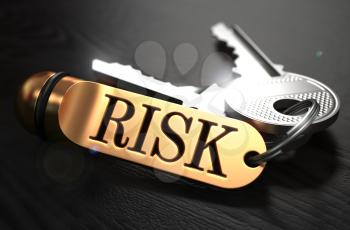 Keys with Word Risk on Golden Label over Black Wooden Background. Closeup View, Selective Focus, 3D Render.