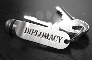 Diplomacy Concept. Keys with Keyring on Black Wooden Table. Closeup View, Selective Focus, 3D Render. Black and White Image.