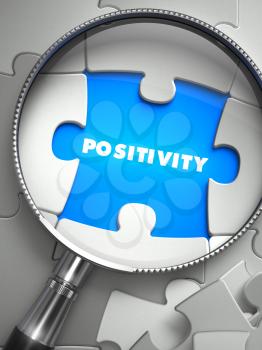 Positivity - Word on the Place of Missing Puzzle Piece through Magnifier. Selective Focus.