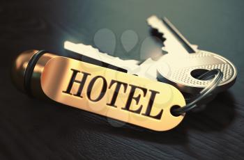 Hotel - Bunch of Keys with Text on Golden Keychain. Black Wooden Background. Closeup View with Selective Focus. 3D Illustration. Toned Image.
