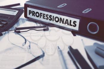 Professionals - Office Folder on Background of Working Table with Stationery, Glasses, Reports. Business Concept on Blurred Background. Toned Image.