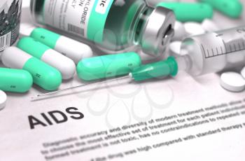 AIDS - Printed Diagnosis with Mint Green Pills, Injections and Syringe. Medical Concept with Selective Focus.