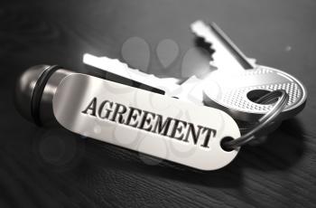 Agreement Concept. Keys with Keyring on Black Wooden Table. Closeup View, Selective Focus, 3D Render. Black and White Image.