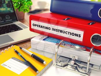 Operating Instructions - Red Office Folder on Background of Working Table with Stationery, Laptop and Reports. Business Concept on Blurred Background. Toned Image.