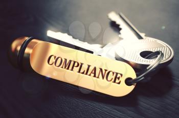 Keys with Word Compliance on Golden Label over Black Wooden Background. Closeup View, Selective Focus, 3D Render. Toned Image.