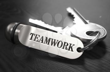 Teamwork Concept. Keys with Keyring on Black Wooden Table. Closeup View, Selective Focus, 3D Render. Black and White Image.