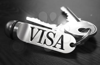 Visa Concept. Keys with Keyring on Black Wooden Table. Closeup View, Selective Focus, 3D Render. Black and White Image.
